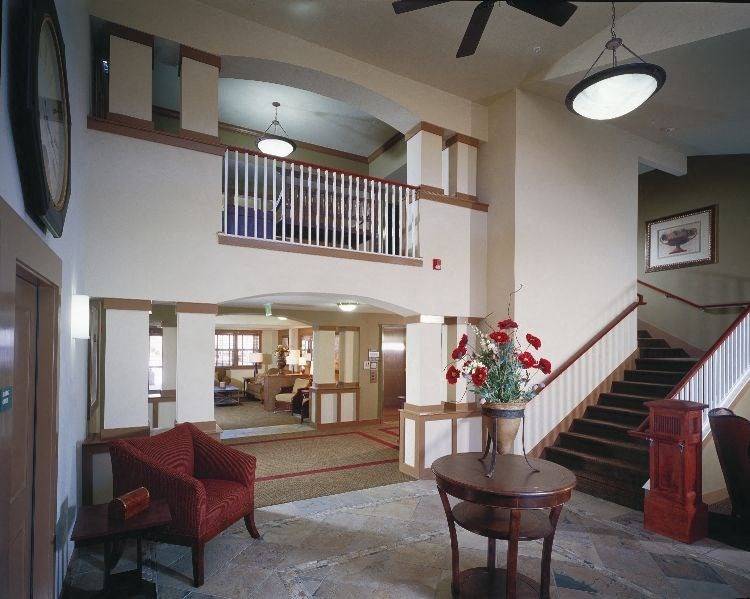 a living room with a staircase and a table
