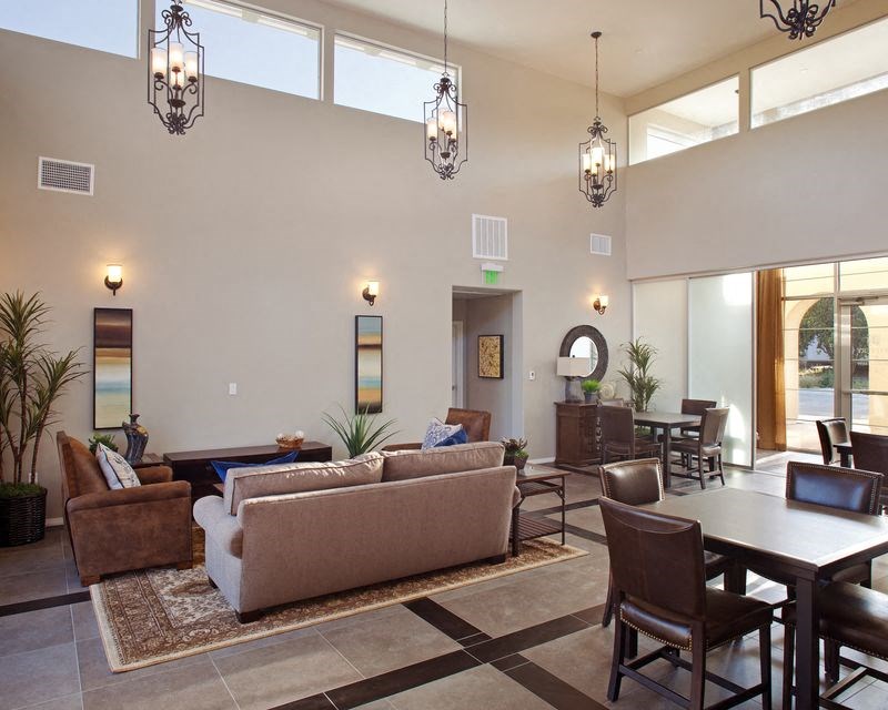 a living room and dining room with couches and chairs