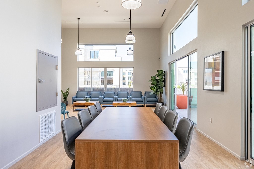 A conference room with a long table and chairs.
