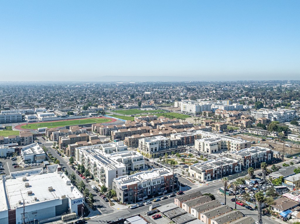 A cityscape with buildings of various sizes and a clear blue sky.