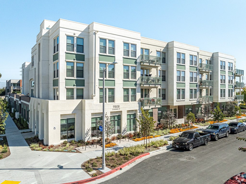 Apartment building 9808 with cars parked in front.