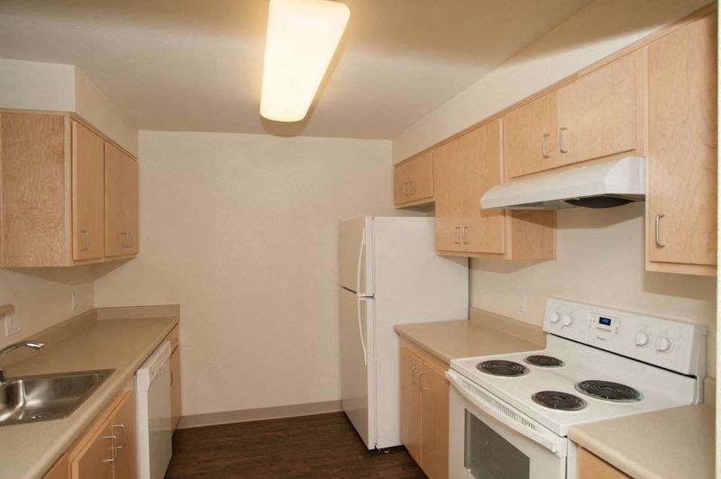 a kitchen with a stove and a refrigerator