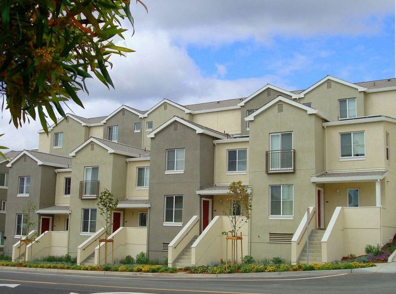 a row of apartment buildings with stairs