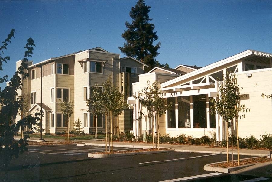 a group of buildings with trees in front of them
