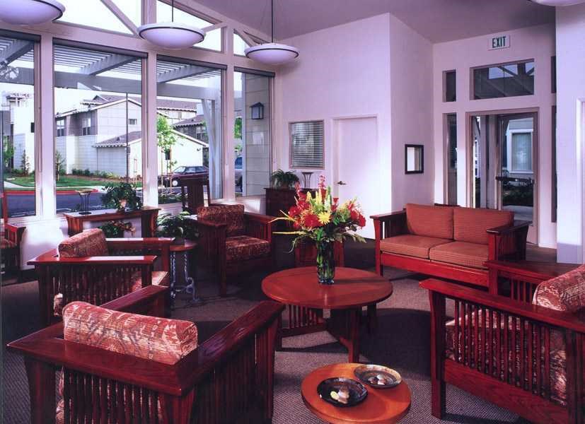 a living room with couches and tables and chairs