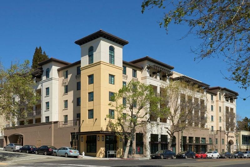 a building with cars parked in front of it on a street