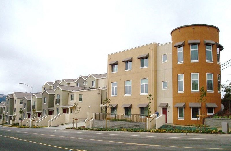 a row of houses on the side of a street