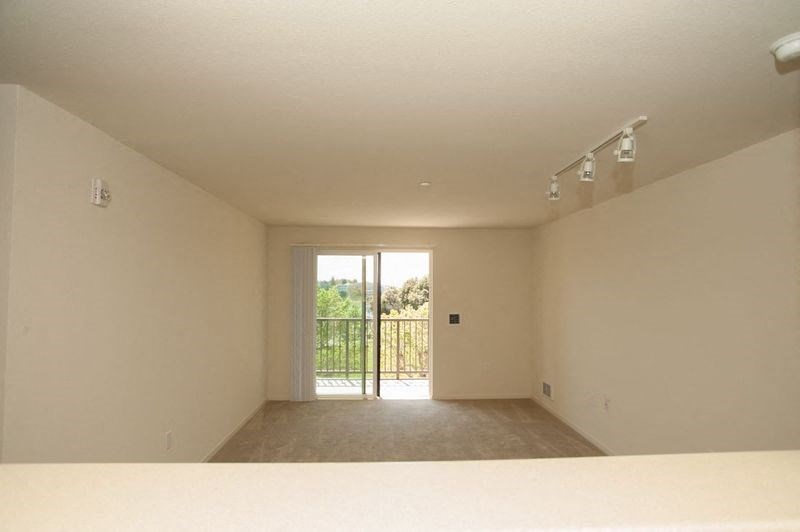 an empty living room with a sliding glass door