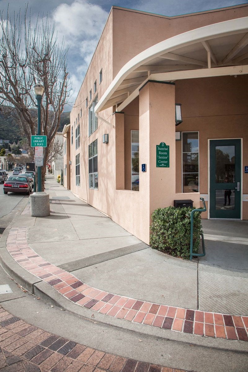 an empty sidewalk in front of a building
