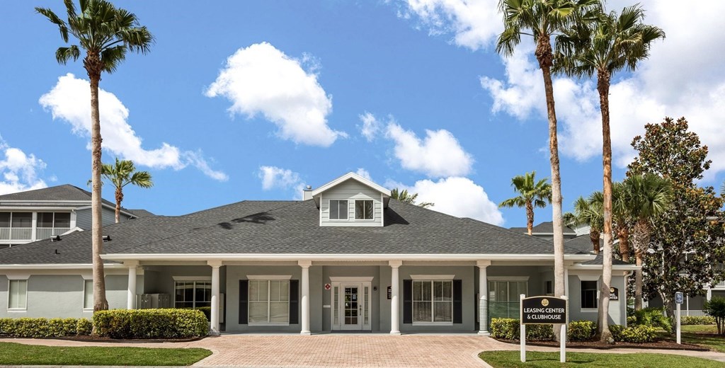 A house with a sign that says "Welcome" in front of it.