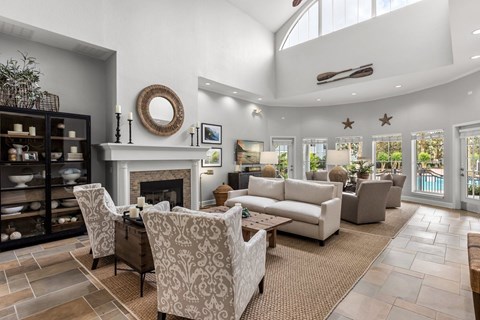A living room with a fireplace and a large mirror on the wall.