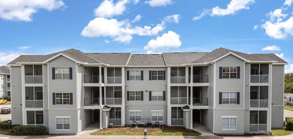 A large apartment complex with multiple balconies and doors.