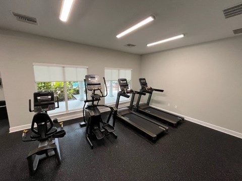 A gym with treadmills and elliptical machines.