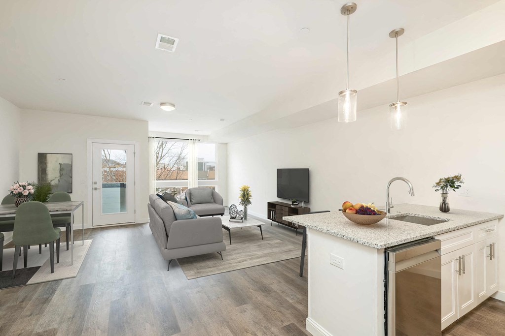 a living room with a couch and a kitchen