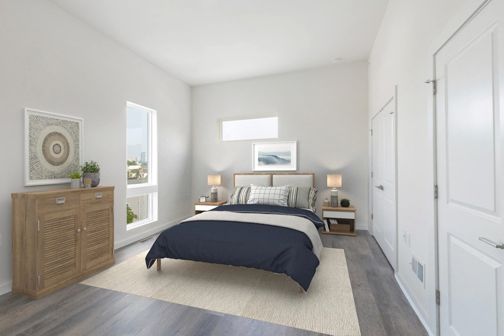 a bedroom with white walls and a bed with a blue comforter