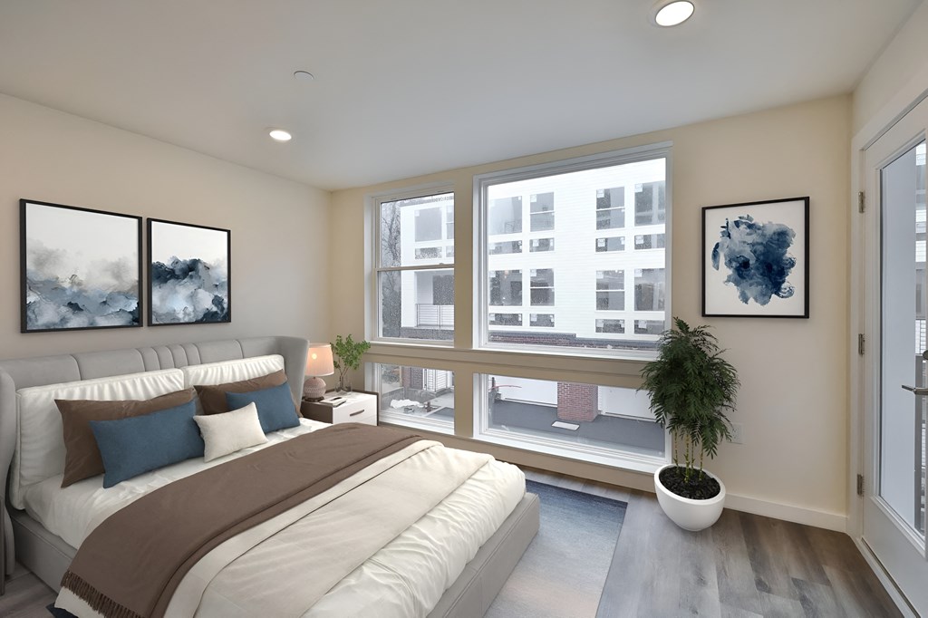 a bedroom with a large bed and a large window