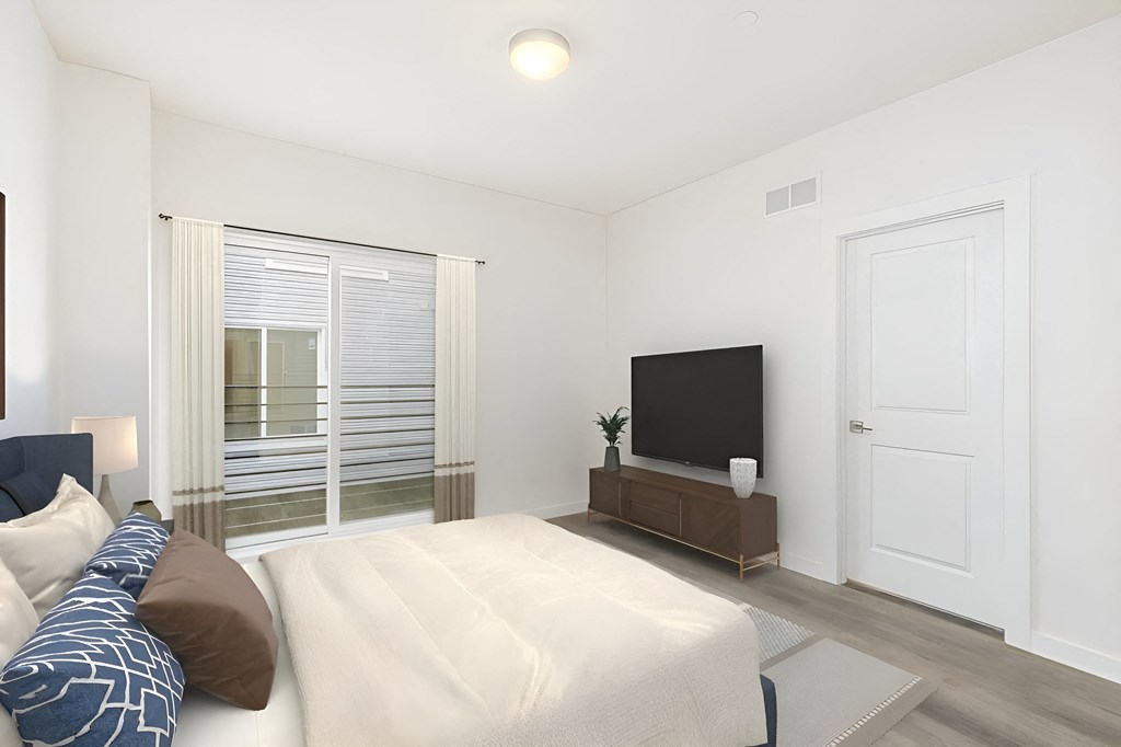 a bedroom with a large bed and a tv