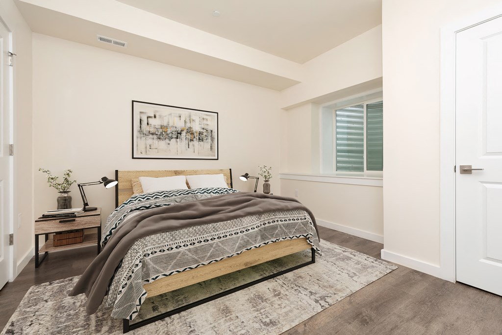 a bedroom with a bed and a window