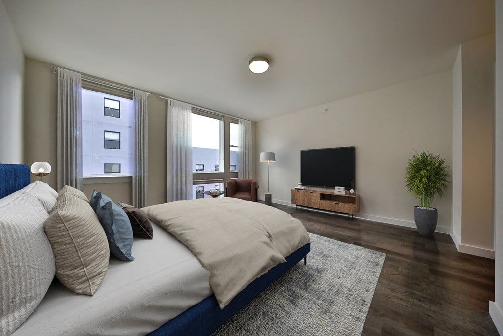 a bedroom with a large bed and a tv