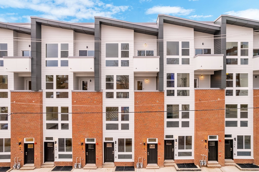 an apartment building with red brick and white windows