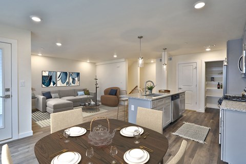 a living room and dining room with a table and chairs