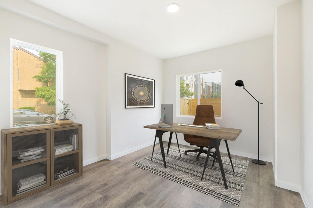 a home office with a desk and a laptop computer on it