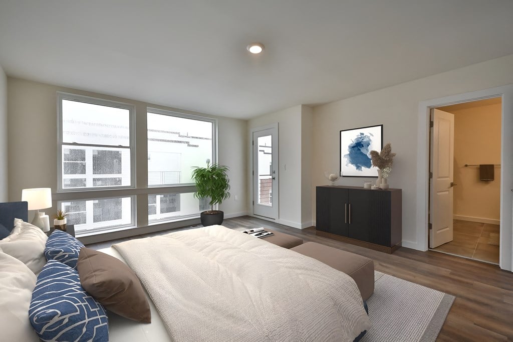 a bedroom with a large bed and a large window