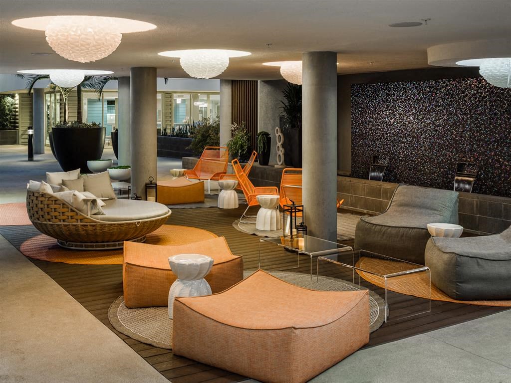 a lobby with couches and chairs and tables