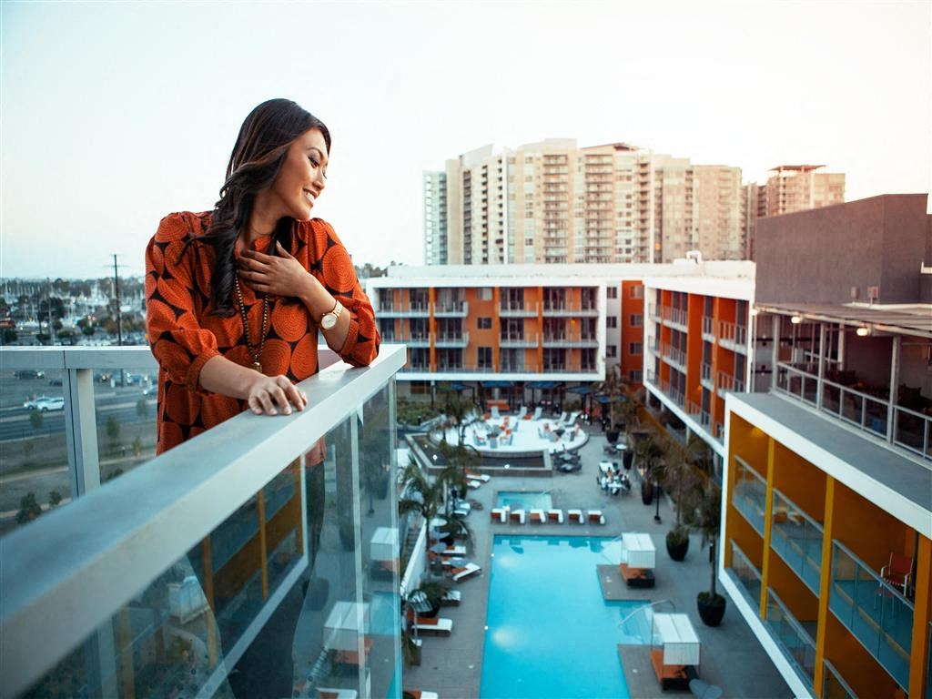 a woman standing on a balcony overlooking a city