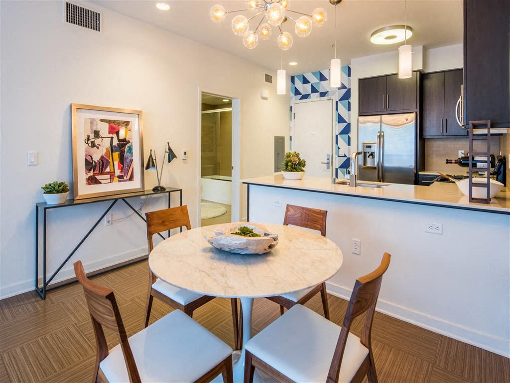 a dining room and kitchen with a table and chairs