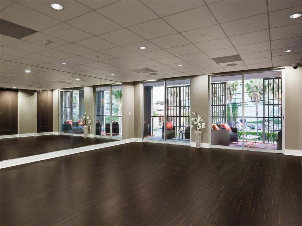 a large room with a wood floor and large windows