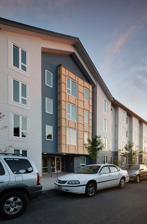 a rendering of a building with cars parked in front of it