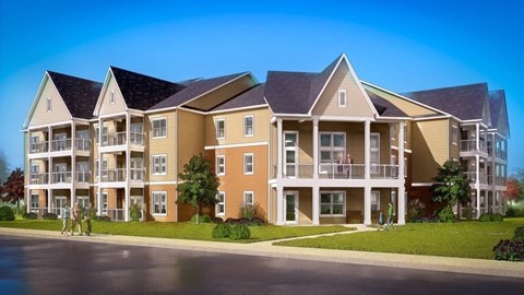 A large apartment complex with multiple balconies and a clear blue sky.
