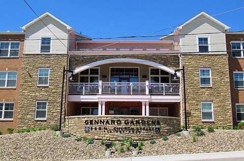 A building with a sign that says "Gennaro Gardens".