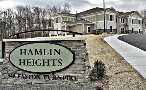 Hamlin Heights residential complex with a bridge and houses in the background.