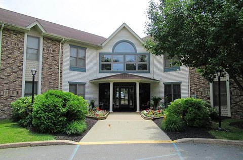 A building with a front yard and a driveway.