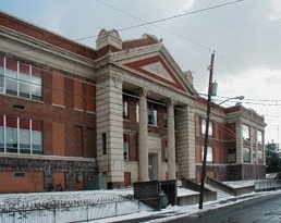 A large red brick building with a white trim.