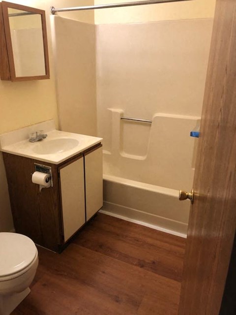 A white toilet is next to a sink in a small bathroom.