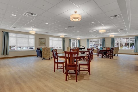 A large room with wooden floors and tables.