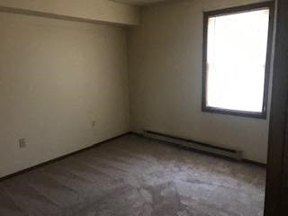 A room with a window and no furniture.