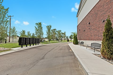 the preserve at ballantyne commons community walkway with benches and a brick building