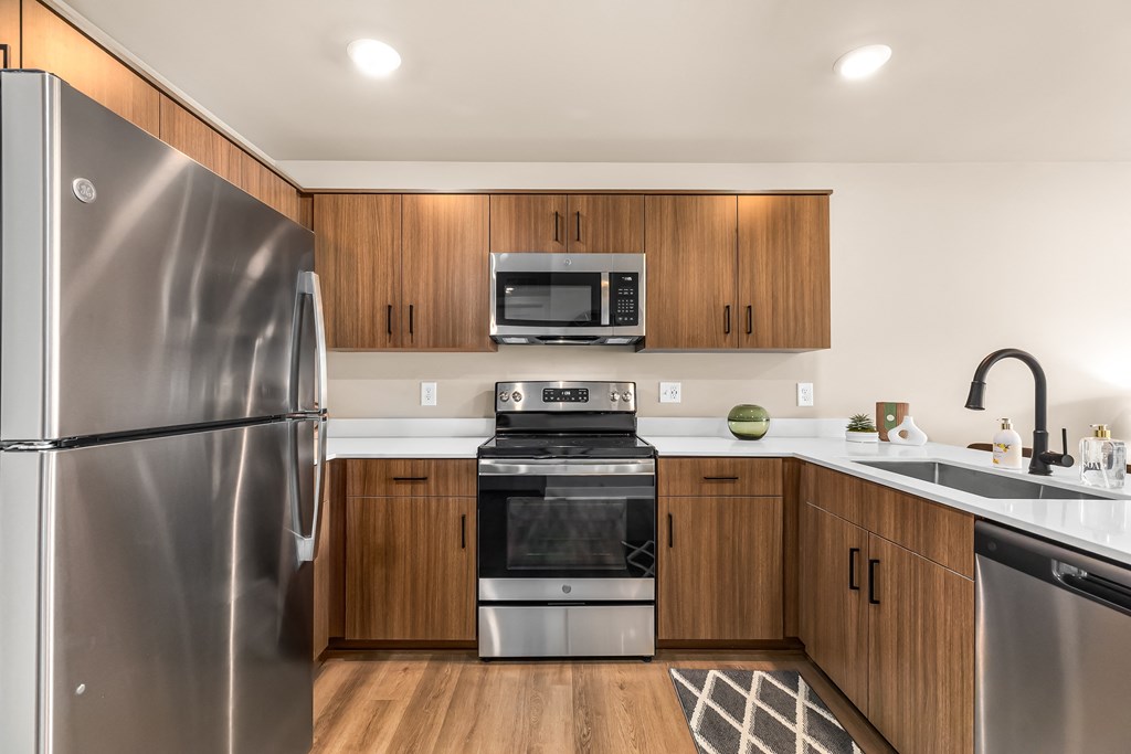 a kitchen with wooden cabinets and stainless steel appliances