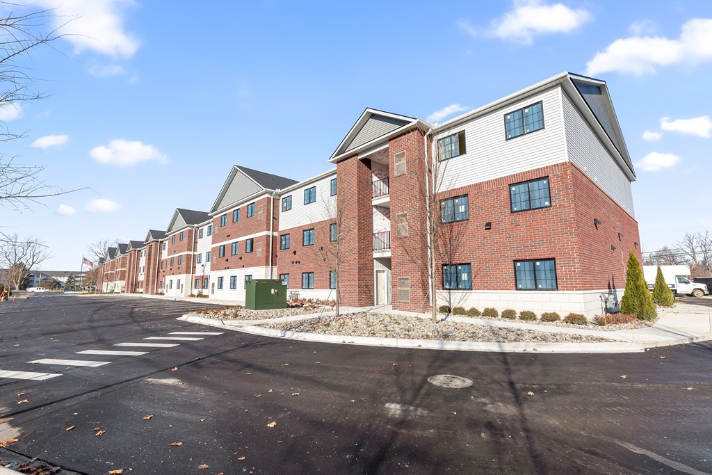 an empty street in front of an apartment building