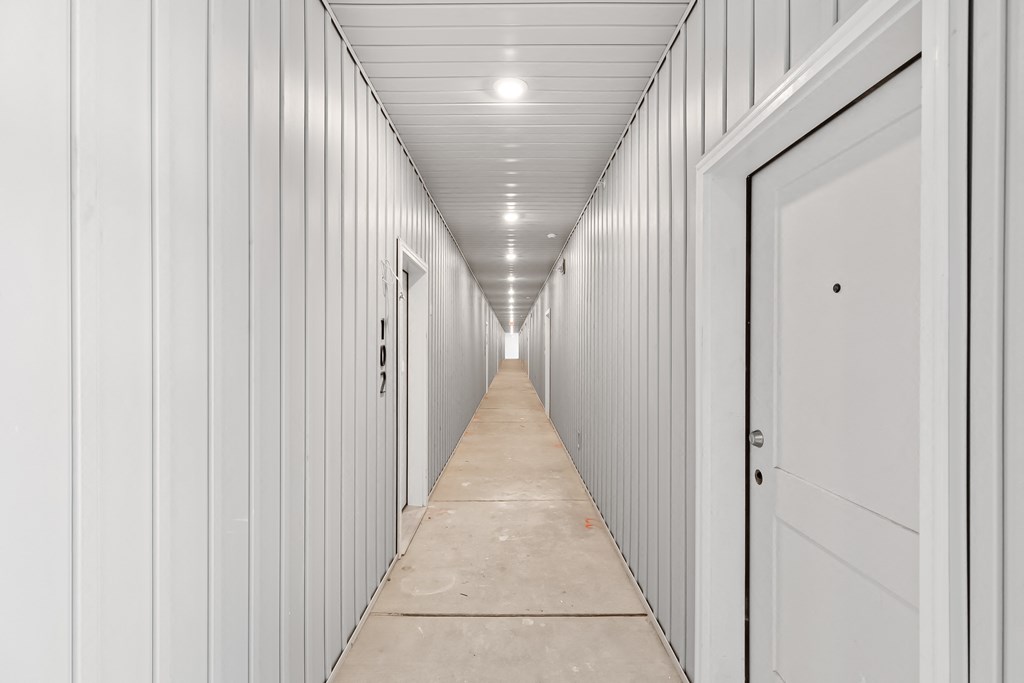 a corridor with white doors in a building