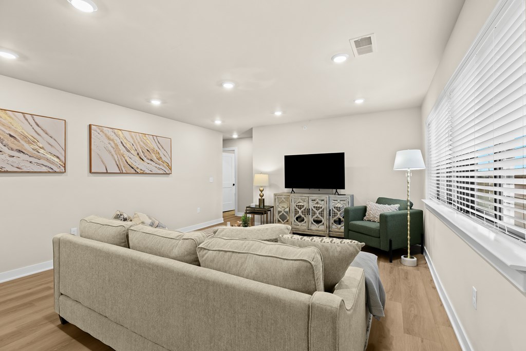 A living room with a large couch and a television.