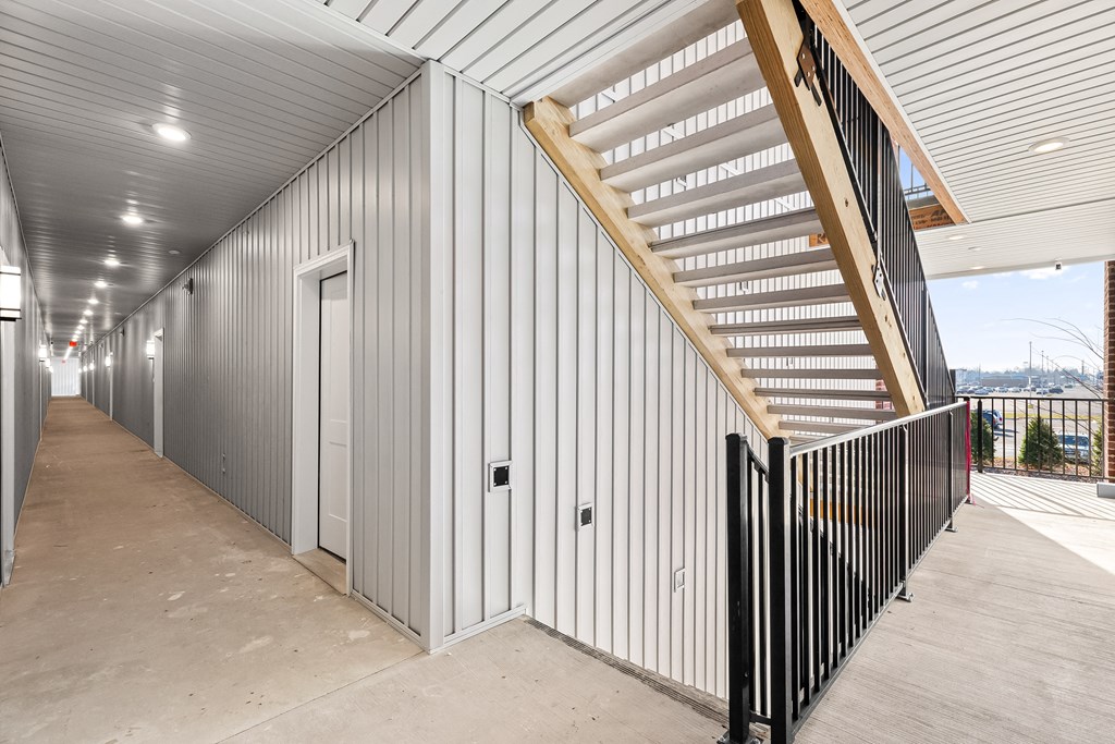 the side of a building with a staircase and a door