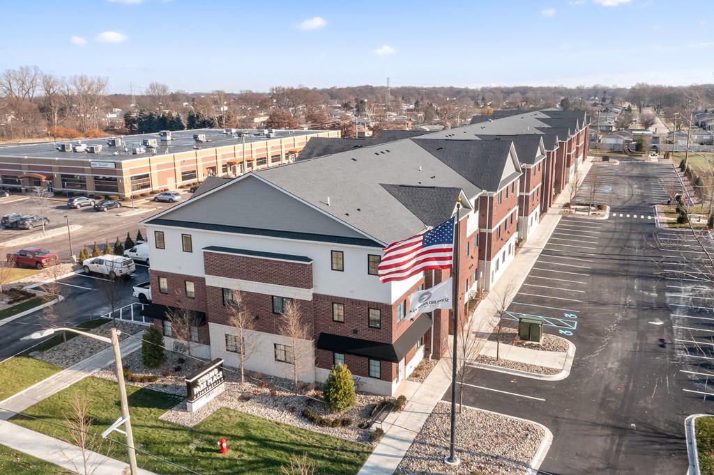 an aerial view of a building with an flag