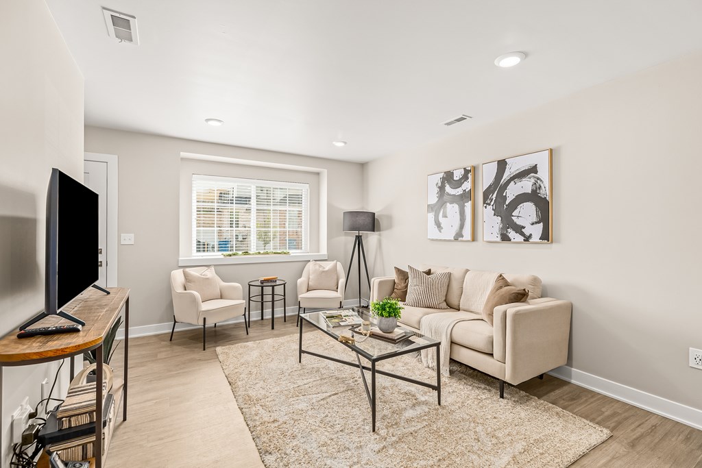 an open living room with a couch and a tv