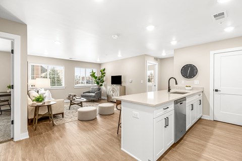 A modern kitchen with white cabinets and a large island.
