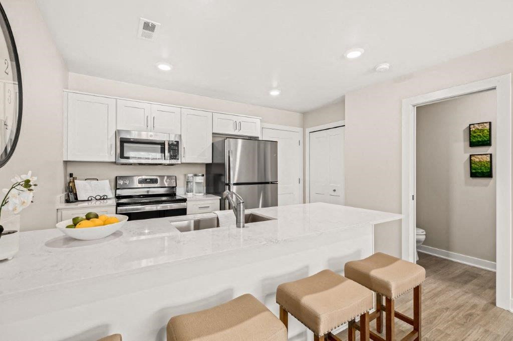 a white kitchen with a counter top and